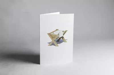 A folded white greeting card with a watercolor illustration of two fish in muted earth tones positioned in the center.