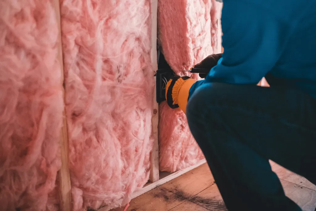 close-up of worker installing insulation