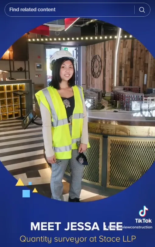 Jessa Lee, Quantity Surveyor at Stage LLP, wears a bright yellow safety vest while standing in a modern construction site office with exposed brick walls and industrial lighting.